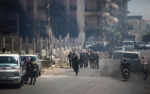 Tribal and bedouin fighters gather in the western neighborhood of southern Syria's predominantly Druze city of Sweida, amid clashes with Druze gunmen on July 19, 2025. (Abdulaziz Ketaz/AFP)