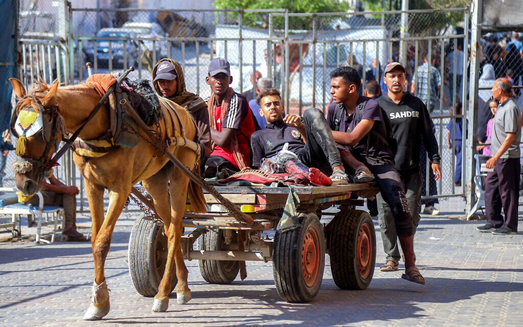 A horse-driven cart carrying injured people arrives at Nasser Medical Complex in Khan Younis in the southern Gaza Strip on July 20, 2025. (AFP)