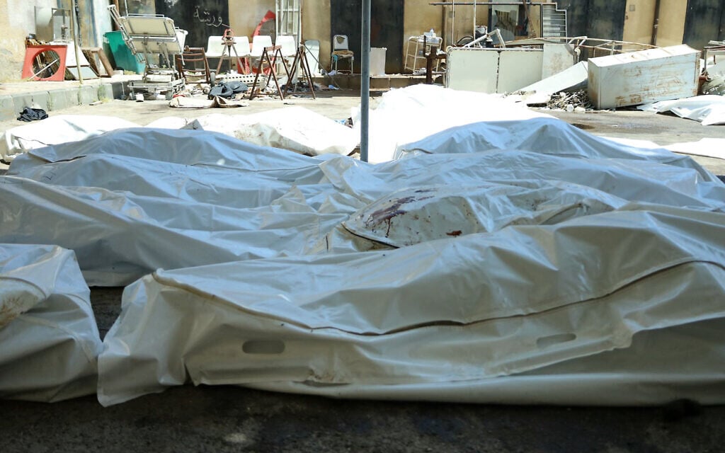 Unidentified bodies of people killed during sectarian violence the previous week lie in bags outside Sweida National Hospital in southern Syria's predominantly Druze city of Sweida on July 20, 2025. (Shadi Al-Dubaisi/AFP)