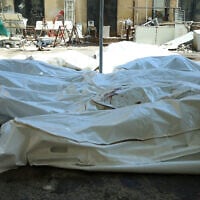 Unidentified bodies of people killed during sectarian violence the previous week lie in bags outside Sweida National Hospital in southern Syria's predominantly Druze city of Sweida on July 20, 2025. (Shadi Al-Dubaisi/AFP)