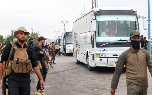 This handout picture released by the official Syrian Arab News Agency (SANA) on July 21, 2025, shows a convoy of buses carrying evacuated Bedouin families in southern Syria's Sweida as government security forces deploy in the area. (SANA / AFP)