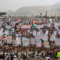 Yemenis lift placards and flags during a rally in solidarity with Palestinians and in condemnation of Israel and the US, in the Houthi-run capital Sanaa on July 25, 2025. (Mohammed HUWAIS / AFP)