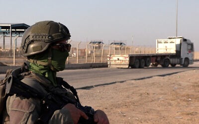An Israeli soldier stands next to a truck at the Kerem Shalom crossing between southern Israel and the Gaza Strip on July 27, 2025. (Carlos REYES / AFP)