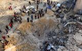 People survey the damage from a reported Israeli airstrike on Khan Younis in the southern Gaza Strip, July 28, 2025. (AFP)