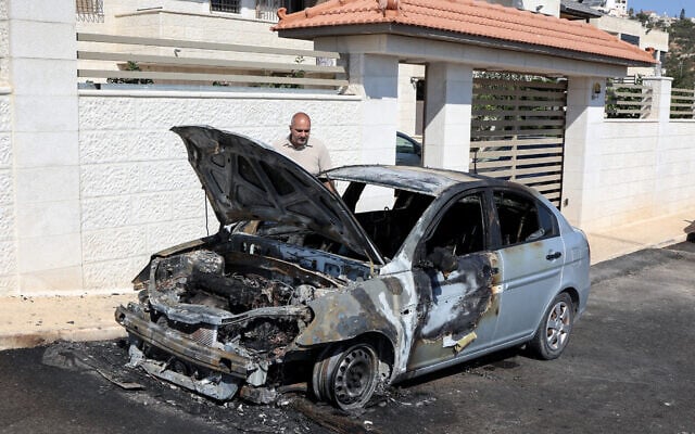 A man inspects a vehicle that was reportedly torched by settlers during an overnight attack on the West Bank Palestinian village of Taybeh, northeast of Ramallah, July 28, 2025. (Photo by Zain JAAFAR / AFP) A man inspects a vehicle that was reportedly torched by settlers during an overnight attack on the West Bank Palestinian village of Taybeh, northeast of Ramallah, July 28, 2025. (Photo by Zain JAAFAR / AFP)