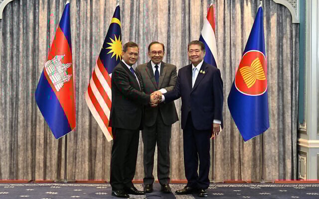 Malaysia's Prime Minister Anwar Ibrahim (C), Cambodia's Prime Minister Hun Manet (L) and Thailand's acting Prime Minister Phumtham Wechayachai (R) pose for photos as they shake hands following a press conference after talks on a possible ceasefire between Thailand and Cambodia in Putrajaya, Malaysia, July 28, 2025. (Mohd Rasfan / POOL / AFP) Malaysia's Prime Minister Anwar Ibrahim (C), Cambodia's Prime Minister Hun Manet (L) and Thailand's acting Prime Minister Phumtham Wechayachai (R) pose for photos as they shake hands following a press conference after talks on a possible ceasefire between Thailand and Cambodia in Putrajaya, Malaysia, July 28, 2025. (Mohd Rasfan / POOL / AFP)