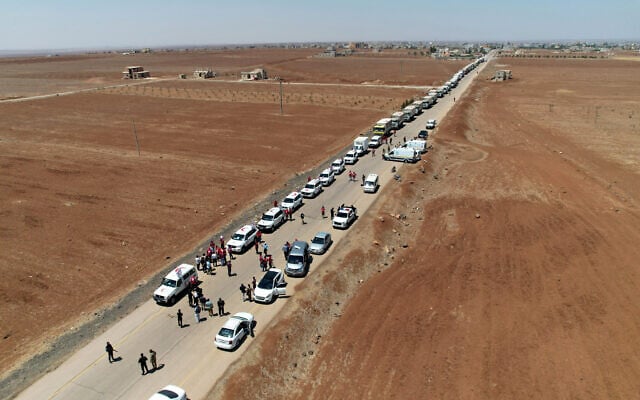 This handout picture released by the official Syrian Arab News Agency (SANA) on July 28, 2025, shows Syrian Red Crescent trucks carrying aid arriving at Busra al-Sham in Syria's southern Daraa province before crossing the buffer zone into Sweida province. (SANA / AFP) This handout picture released by the official Syrian Arab News Agency (SANA) on July 28, 2025, shows Syrian Red Crescent trucks carrying aid arriving at Busra al-Sham in Syria's southern Daraa province before crossing the buffer zone into Sweida province. (SANA / AFP)