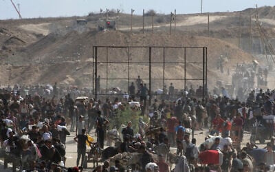 Displaced Palestinians gather to receive aid from a GHF aid distribution point in the so-called 'Netzarim corridor' area in the central Gaza Strip on July 30, 2025. (Eyad Baba/AFP)