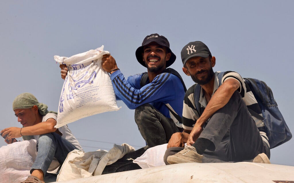 A Palestinian man shows off a bag of humanitarian aid he received in Rafah, in the southern Gaza Strip on July 30, 2025. (Photo by AFP)