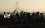 Israeli right-wing protesters gather on a hill overlooking the Gaza Strip near the border fence on July 30, 2025, during a rally to mark 20 years since Israel's withdrawal from Gaza (Menahem KAHANA / AFP)