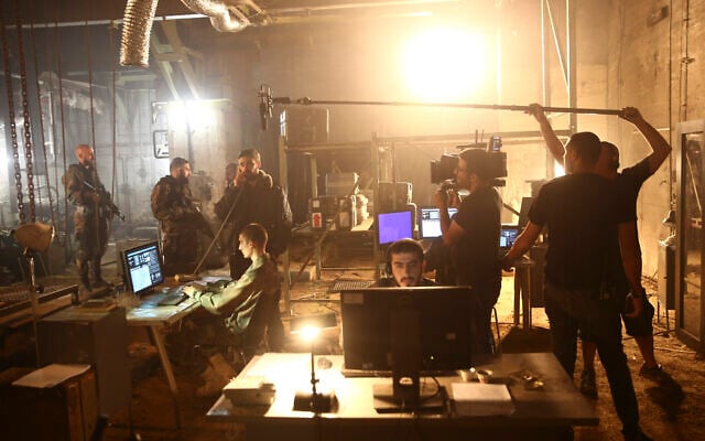 Illustrative: A film crew shoots a scene from the hit TV show 'Fauda' in Tel Aviv on May 30, 2019. (AP/Oded Balilty)
