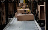 Boxes sit on a conveyor belt at an Amazon storage warehouse in Tepotzotlan, Mexico, May 22, 2025. (AP Photo/Marco Ugarte)