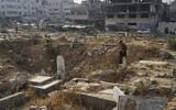 A Palestinian visits Sheikh Radwan cemetery in Gaza City on the first day of Eid al-Adha, Friday, June 6, 2025. (AP/Jehad Alshrafi)