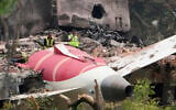 Officials inspect the site of an Air India plane crash that killed at least 260 people, on the roof of a building in Ahmedabad, India, June 13, 2025. (AP Photo/Ajit Solanki)