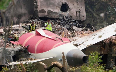 Officials inspect the site of an Air India plane crash that killed at least 260 people, on the roof of a building in Ahmedabad, India, June 13, 2025. (AP Photo/Ajit Solanki)