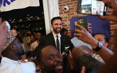 Democratic mayoral candidate Zohran Mamdani takes selfies with supporters after speaking at his primary election party, June 25, 2025, in New York. (AP Photo/Heather Khalifa)
