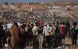 Palestinians carry humanitarian aid packages near the Gaza Humanitarian Foundation distribution center operated by the US-backed organization in Khan Younis, southern Gaza Strip, Thursday, June 26, 2025. (AP Photo/Abdel Kareem Hana)
