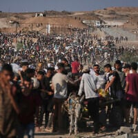 Palestinians carry humanitarian aid packages near the Gaza Humanitarian Foundation distribution center operated by the US-backed organization in Khan Younis, southern Gaza Strip, Thursday, June 26, 2025. (AP Photo/Abdel Kareem Hana)