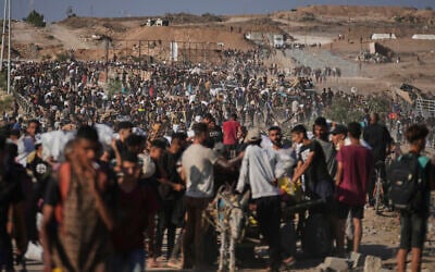 Palestinians carry humanitarian aid packages near the Gaza Humanitarian Foundation distribution center operated by the US-backed organization in Khan Younis, southern Gaza Strip, Thursday, June 26, 2025. (AP Photo/Abdel Kareem Hana)