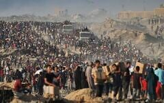 Palestinians carry sacks and boxes of food and humanitarian aid, unloaded from a World Food Program convoy heading to Gaza City in the northern Gaza Strip, June 16, 2025. (AP Photo/Jehad Alshrafi)