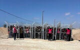 This photo, provided by an American contractor on condition of anonymity because they were revealing their employers’ internal operations, shows Palestinians behind gates before entering a food distribution site operated by the Gaza Humanitarian Foundation in May 2025, shortly after the start of the organization's distribution sites. (AP Photo)