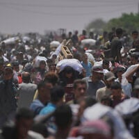 Palestinians carry bags containing food and humanitarian aid packages delivered by the Gaza Humanitarian Foundation in Rafah, southern Gaza Strip, June 9, 2025. (AP Photo/Abdel Kareem Hana)