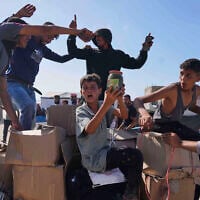 Palestinians carry boxes containing food and humanitarian aid packages delivered by the Gaza Humanitarian Foundation, in Rafah, southern Gaza Strip, May 27, 2025. (AP Photo/Abdel Kareem Hana)