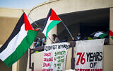 Anti-Israel, Pro-Palestinian US protesters wave flags from the second level of the Physical Sciences Lecture Hall after they took over the building at the University of California, Irvine, May 15, 2024, in Irvine, California. (Leonard Ortiz/The Orange County Register via AP, File)