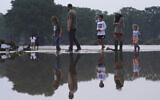 Onlookers survey damage along the Guadalupe River after a flash flood swept through the area, Friday, July 4, 2025, in Kerrville, Texas. (AP Photo/Eric Gay)