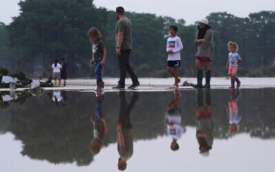Onlookers survey damage along the Guadalupe River after a flash flood swept through the area, Friday, July 4, 2025, in Kerrville, Texas. (AP Photo/Eric Gay)