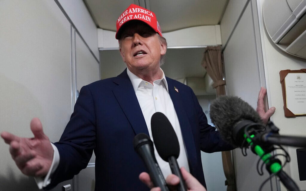 US President Donald Trump speaks to reporters on board Air Force One, en route from Joint Base Andrews, Maryland, to Morristown Municipal Airport in Morristown, New Jersey, July 4, 2025. (AP/Jacquelyn Martin)