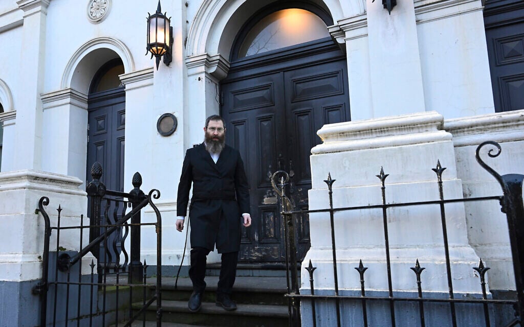Rabbi Dovid Gutnick walks past damage to the exterior of the East Melbourne Hebrew Congregation in Melbourne, July 5, 2025, after an arsonist set fire to the door. (James Ross/AAP Image via AP)