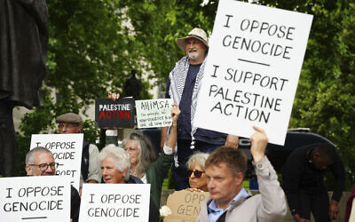 People take part in a protest in support of 'Palestine Action', organized by the Defend Our Juries group, in front of the Mahatma Gandhi statue in Parliament Square in London, England, July 5, 2025. (Jeff Moore/PA via AP)
