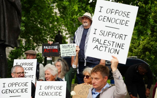 People take part in a protest in support of 'Palestine Action', organized by the Defend Our Juries group, in front of the Mahatma Gandhi statue in Parliament Square in London, England, July 5, 2025. (Jeff Moore/PA via AP) People take part in a protest in support of 'Palestine Action', organized by the Defend Our Juries group, in front of the Mahatma Gandhi statue in Parliament Square in London, England, July 5, 2025. (Jeff Moore/PA via AP)