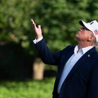 US President Donald Trump looks up at the American flag on the flagpole on the South Lawn as he arrives at the White House, July 6, 2025, in Washington. (AP/Manuel Balce Ceneta)