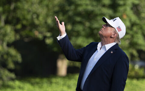 US President Donald Trump looks up at the American flag on the flagpole on the South Lawn as he arrives at the White House, July 6, 2025, in Washington. (AP/Manuel Balce Ceneta)
