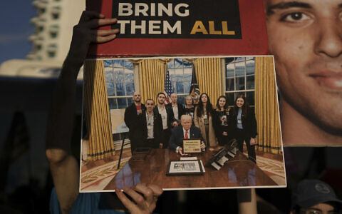 People hold a picture of US President Donald Trump meeting former hostages in the White House as they attend a rally calling for the release of hostages in front of the US Embassy branch office in Tel Aviv, Israel, Monday, July 7, 2025. (AP/Oded Balilty)