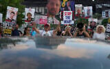 Relatives of hostages held by Hamas in the Gaza Strip and their supporters call for an immediate hostage release deal during a protest in Tel Aviv, Israel, Thursday, July 10, 2025. (AP Photo/Ariel Schalit)