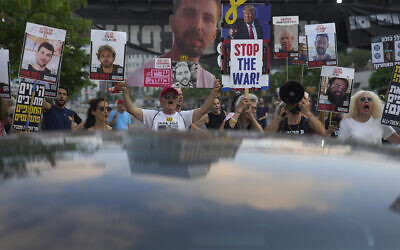 Relatives of hostages held by Hamas in the Gaza Strip and their supporters call for an immediate hostage release deal during a protest in Tel Aviv, Israel, Thursday, July 10, 2025. (AP Photo/Ariel Schalit)