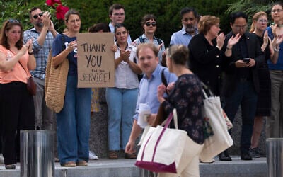 US State Department employees applaud as their colleagues walk outside of the State Department headquarters in the Harry S Truman Building, July 11, 2025, in Washington. (AP Photo/Manuel Balce Ceneta)