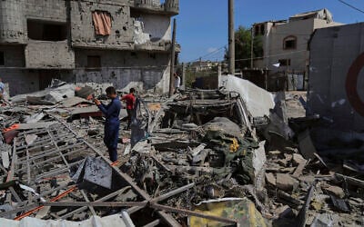 Palestinians inspect the wreckage of a gas station destroyed in an Israeli airstrike in Deir al-Balah, central Gaza Strip, July 12, 2025. (AP Photo/Abdel Kareem Hana)