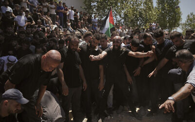 Mourners gather around the graves of Palestinian-American Saif Musallet, 20, and Mohammed al-Shalabi during their funeral in the West Bank village of Al-Mazraa ash-Sharqiya on Sunday, July 13, 2025. (AP/Leo Correa) Mourners gather around the graves of Palestinian-American Saif Musallet, 20, and Mohammed al-Shalabi during their funeral in the West Bank village of Al-Mazraa ash-Sharqiya on Sunday, July 13, 2025. (AP/Leo Correa)