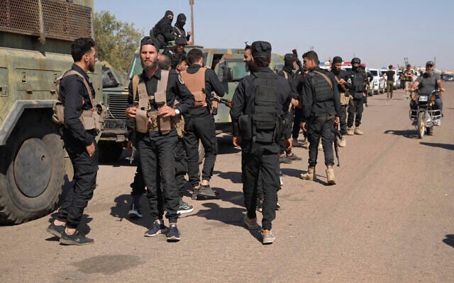 Syrian government security forces gather on the outskirts of Sweida province where clashes erupted between Druze militias and Sunni Bedouin clans, southern Syria, July 14, 2025. (AP Photo/Malek Khattab)