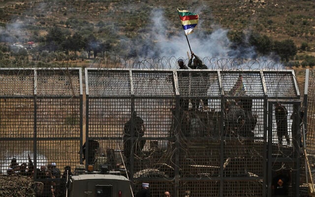 Syrian Druze protest near the Israeli-Syrian border, as seen from the town of Majdal Shams in the Golan Heights, Wednesday, July 16, 2025 (AP Photo/Leo Correa)