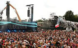 People listen at the Tomorrowland music festival in Boom, Belgium, July 18, 2025. (AP Photo/Omar Havana)