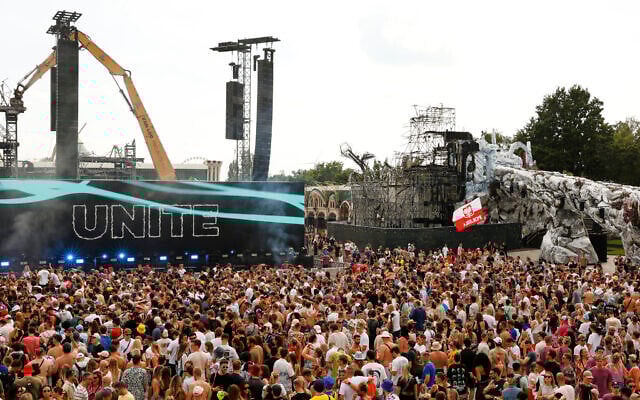 People listen at the Tomorrowland music festival in Boom, Belgium, July 18, 2025. (AP Photo/Omar Havana)