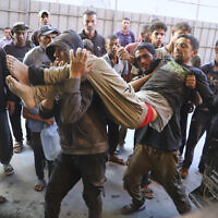 A Palestinian man said to have been injured near a food distribution center run by the Gaza Humanitarian Foundation, a US- and Israel-backed organization, is carried into Nasser Hospital in Khan Younis, southern Gaza Strip, July 19, 2025. (AP Photo/Mariam Dagga)