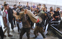 A Palestinian man said to have been injured during a food distribution at a center run by the Gaza Humanitarian Foundation, a US- and Israel--backed organization approved by Israel, is carried into Nasser Hospital in Khan Younis, southern Gaza Strip, July 19, 2025. (AP Photo/Mariam Dagga)