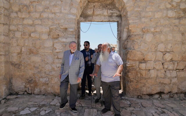 US Ambassador to Israel Mike Huckabee, left, is escorted by Father Jack-Noble Abed, priest of the Melkite Greek Catholic Church, during a tour in the archeological site of the Church of St. George, the site of a recent Israeli settlers attacks, during his visit to the West Bank town of Taybeh, east of Ramallah Saturday, July 19, 2025. (AP Photo/Nasser Nasser) US Ambassador to Israel Mike Huckabee, left, is escorted by Father Jack-Noble Abed, priest of the Melkite Greek Catholic Church, during a tour in the archeological site of the Church of St. George, the site of a recent Israeli settlers attacks, during his visit to the West Bank town of Taybeh, east of Ramallah Saturday, July 19, 2025. (AP Photo/Nasser Nasser)