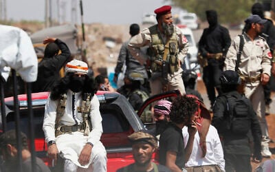 Syrian government security forces block Bedouin fighters, foreground, from entering Sweida province, in Busra al-Harir village, southern Syria, July 20, 2025. (AP Photo/Omar Sanadiki)